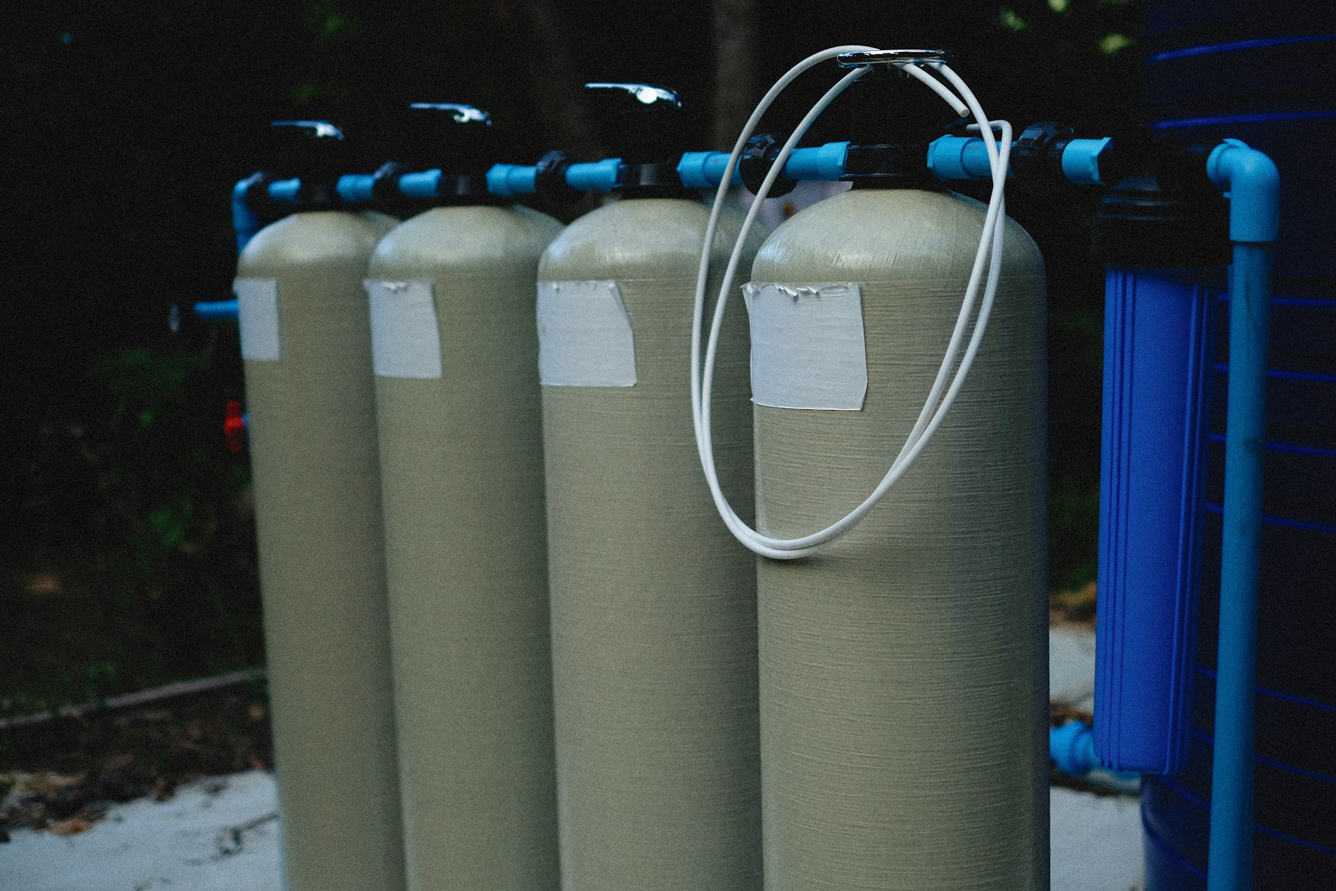 Industrial water filtration skids and tanks — engineered treatment and RO-style systems. Photo: Alexey Demidov on Unsplash.
