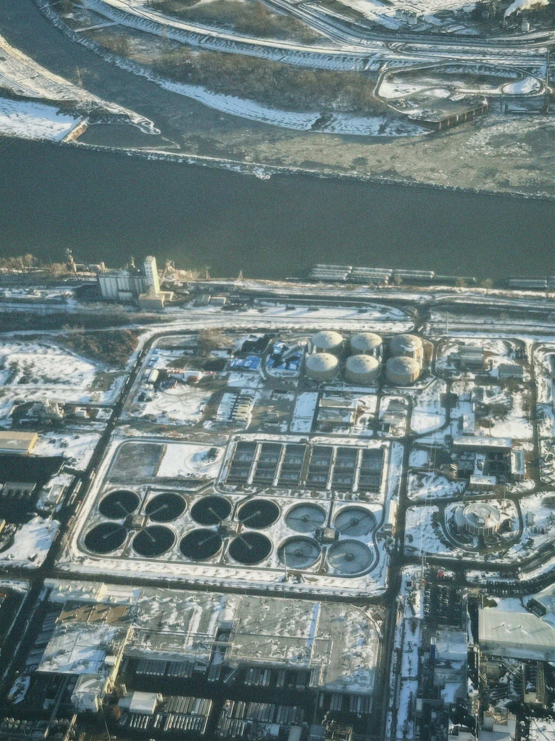 Large-scale industrial site by a river — compliance, hydrology, and site-scale engineering context. Photo: Christopher Stites on Unsplash.